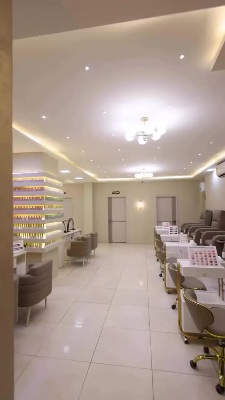Manicure stations under warm cove lighting
